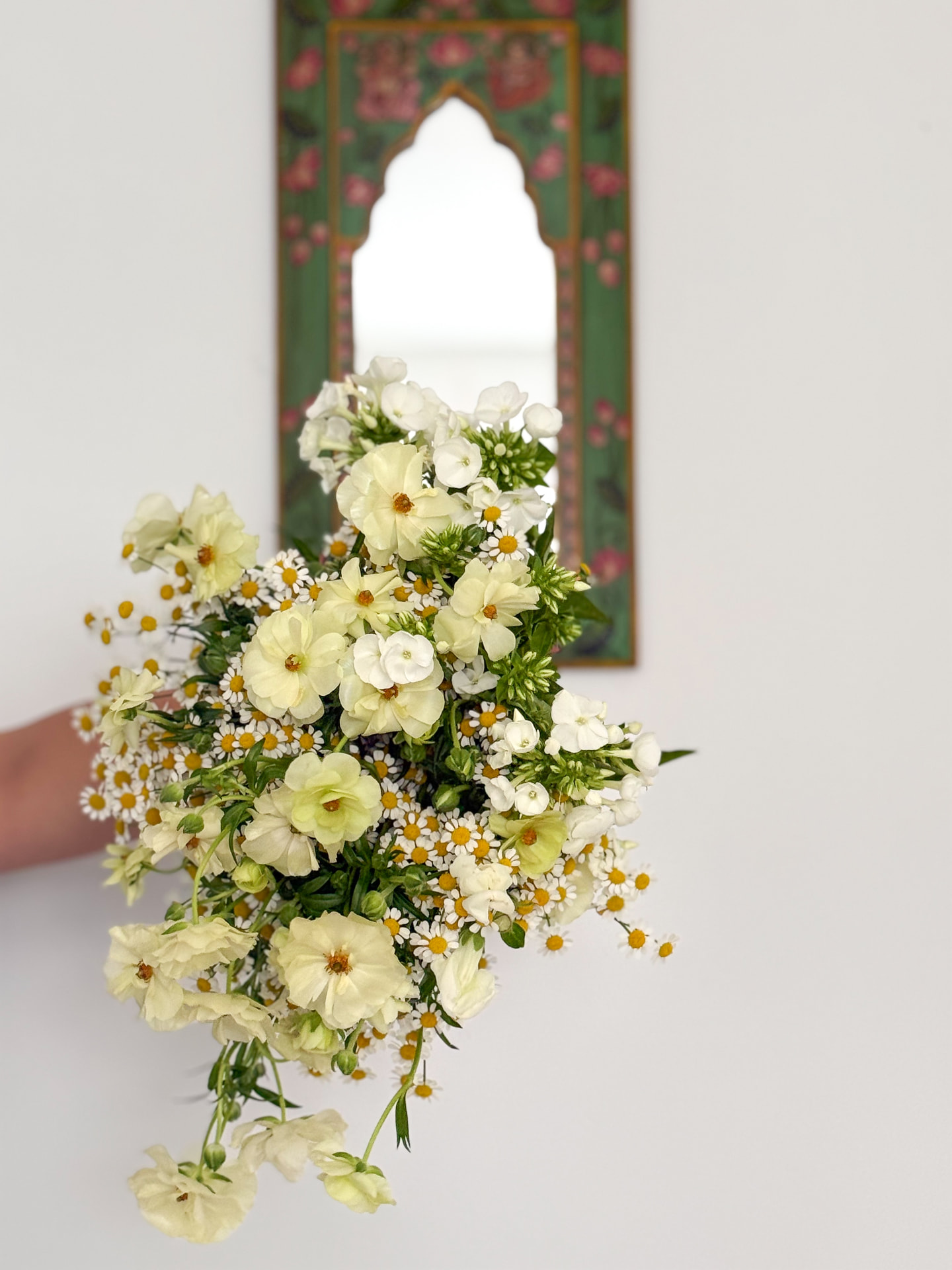 Cream and white bouquet of ranunculus and chamomile daisies